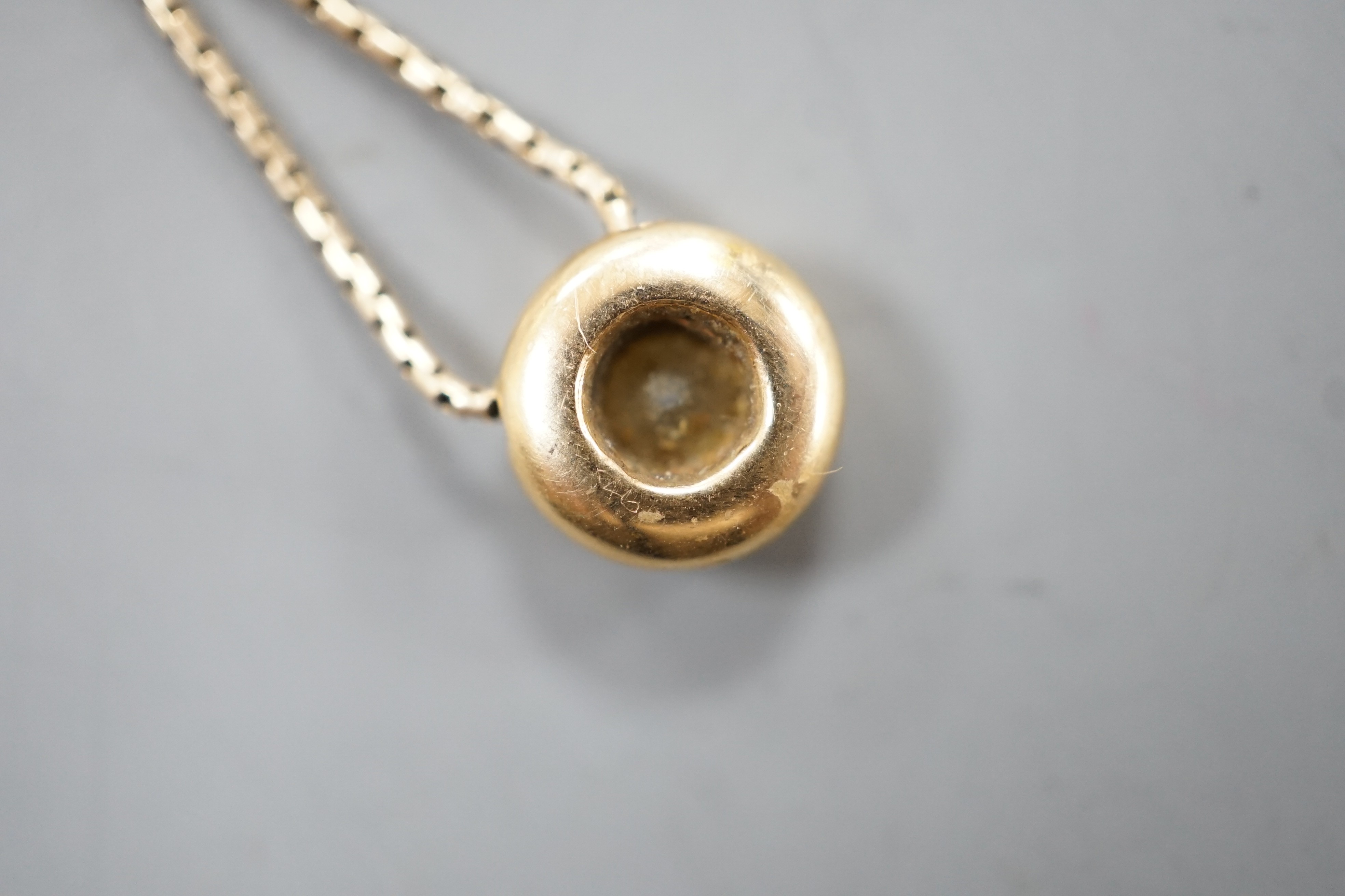 A modern 9ct gold and solitaire diamond set pendant necklace, pendant 9mm, chain, 39cm, gross weight 4.5 grams.